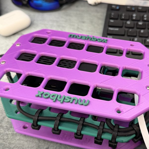 Purple and teal Mushbox build on a workbench