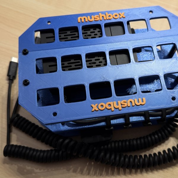 Blue Mushbox with orange lettering