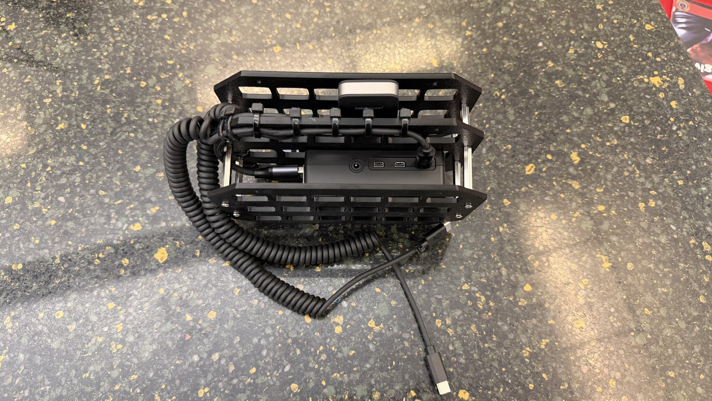 Inside a black Mushbox showing the board, hub, and coiled cable routing